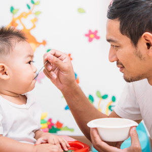 dad feeding child